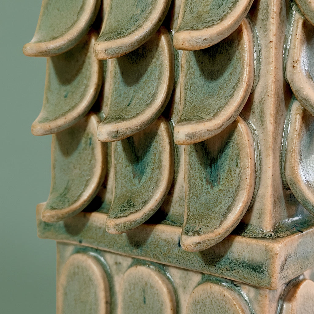 Handmade decorative ceramic form glazed with a mottled green glaze